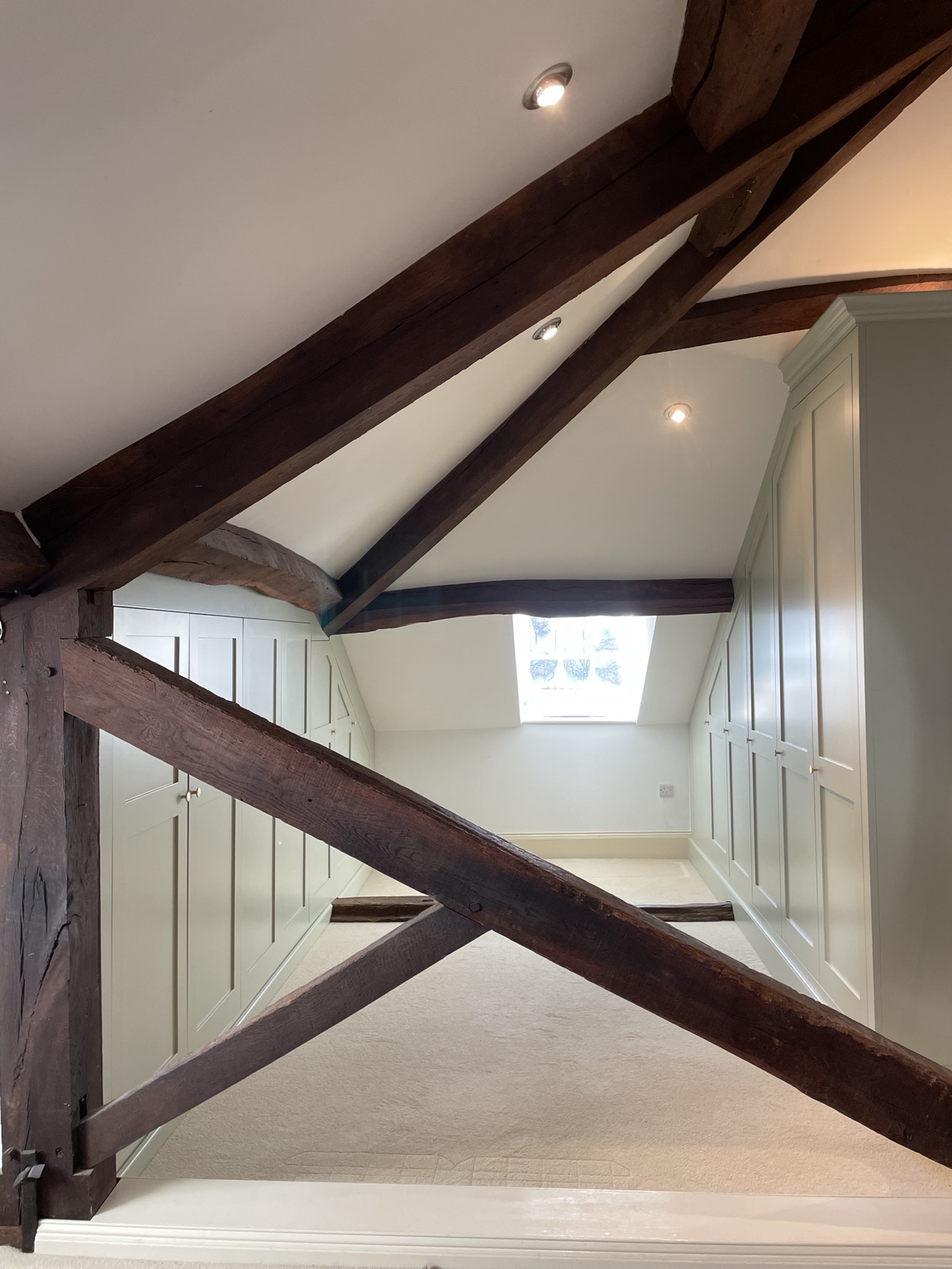 Fitted attic wardrobes shaped around roof timbers