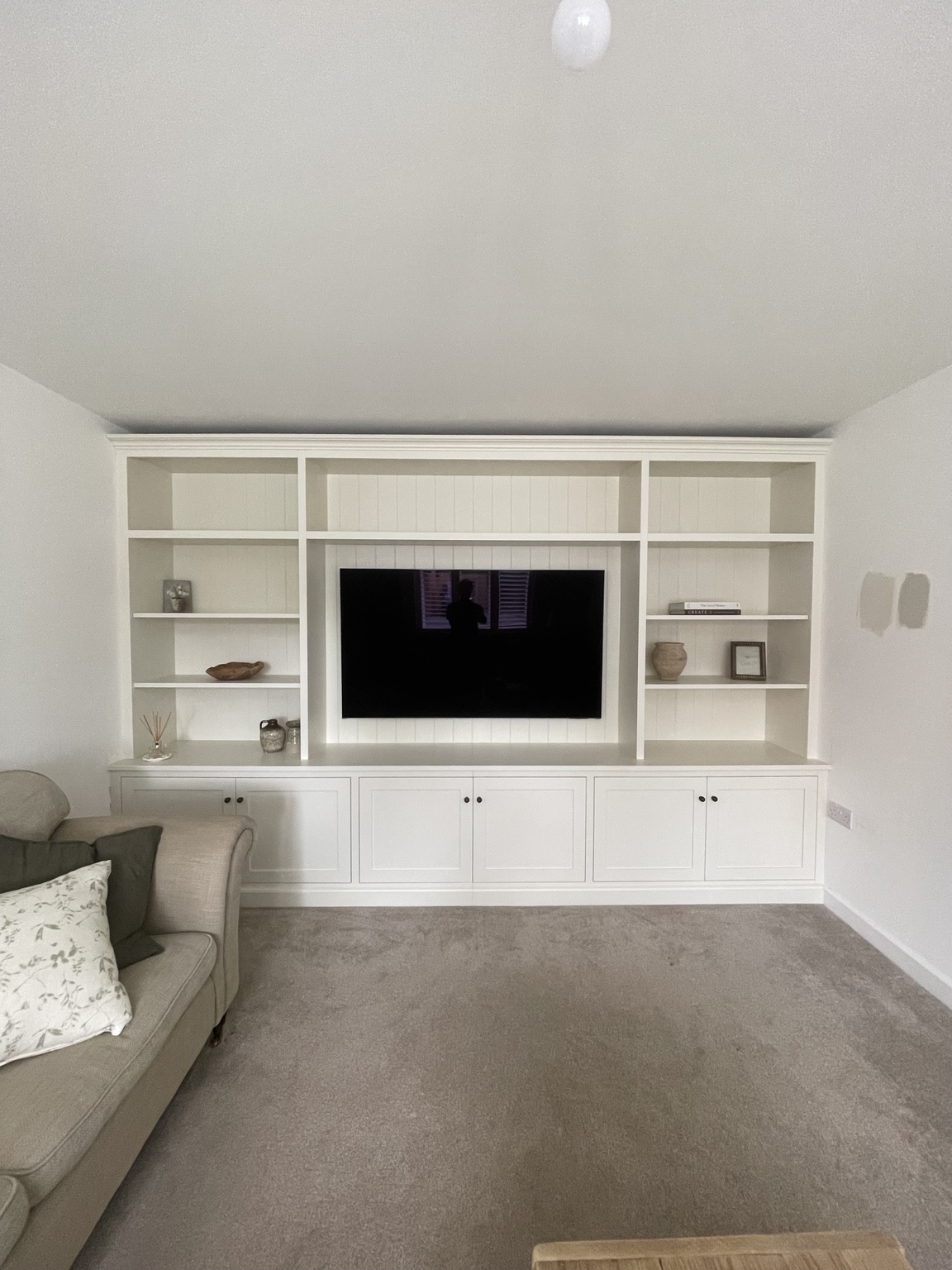 Traditional painted media wall with open shelving and shaker cabinetry
