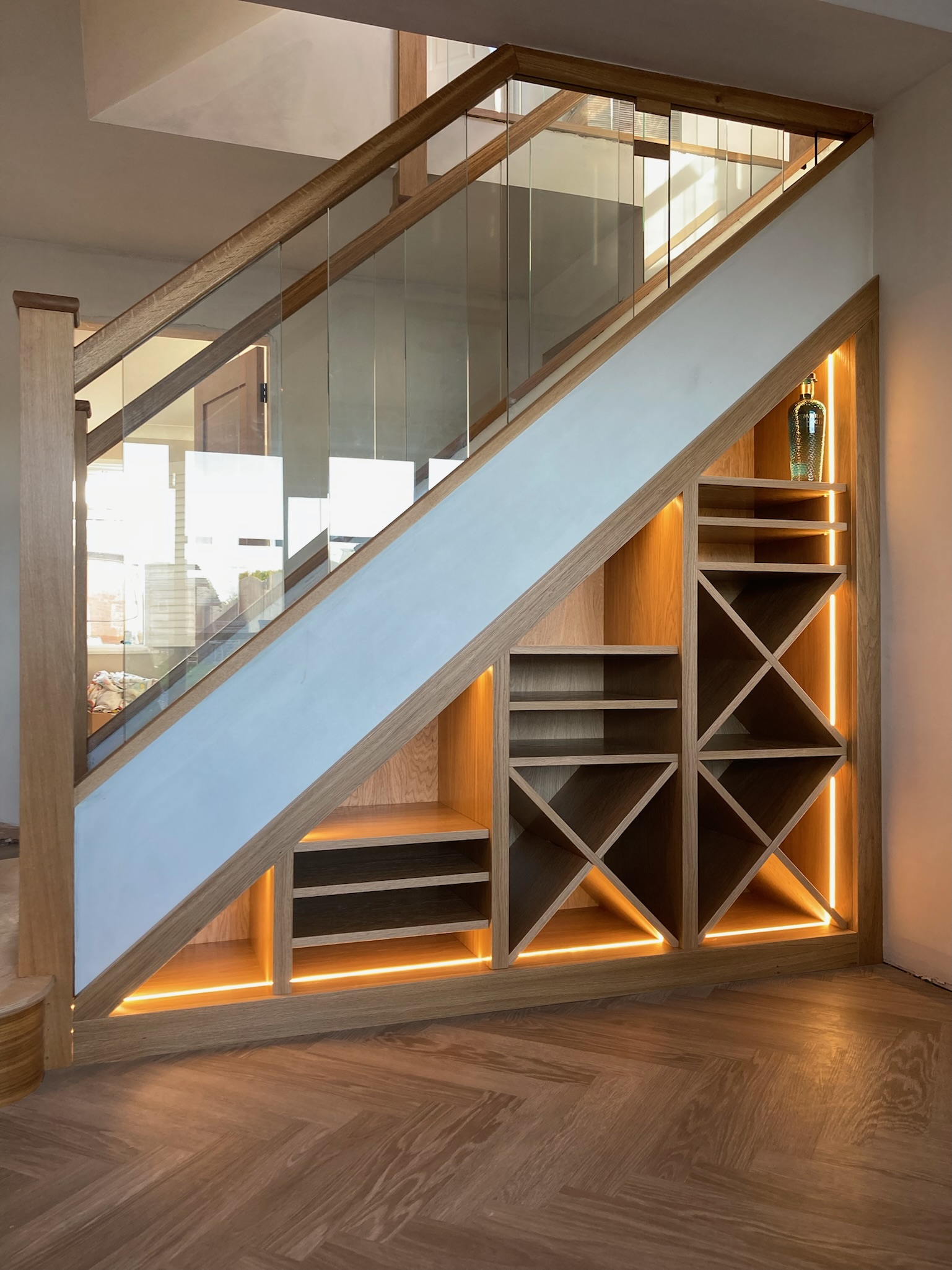 Bespoke oak wine storage beneath a staircase