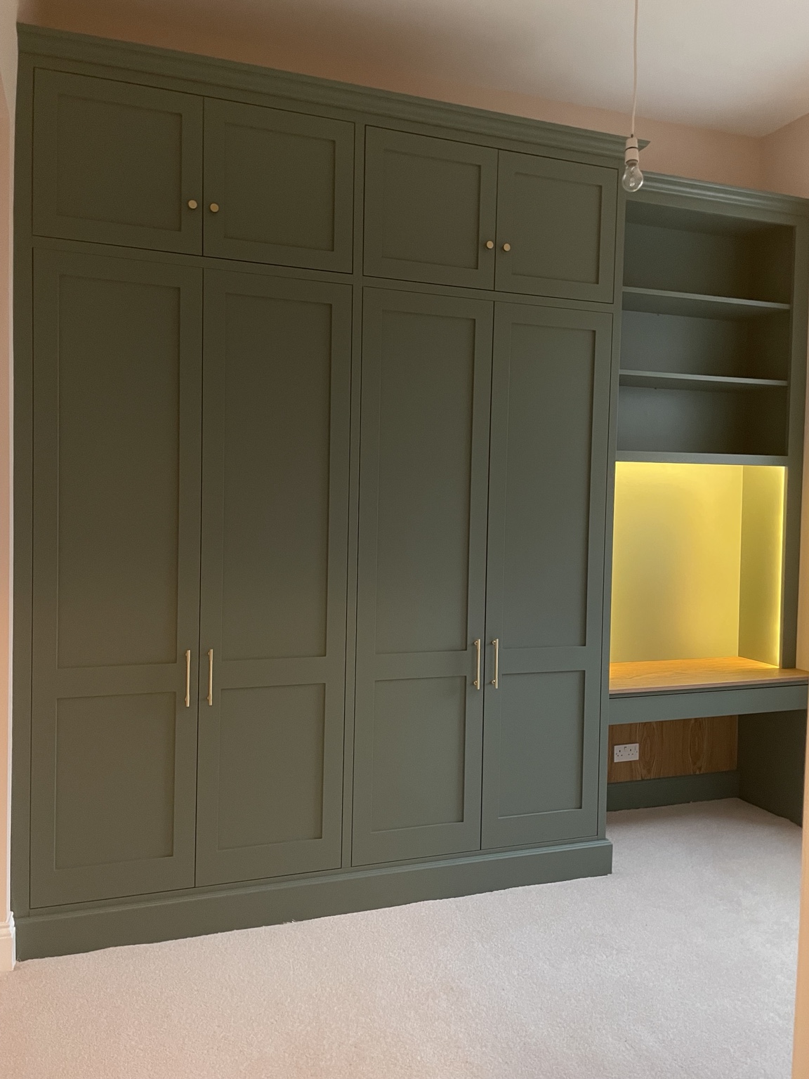 Sage green fitted wardrobes with integrated dressing table