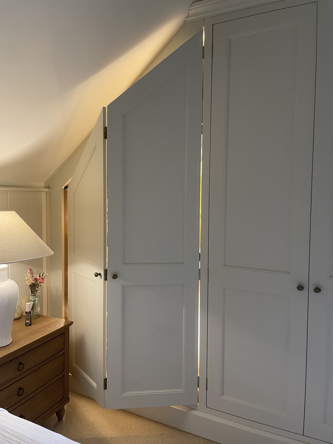 Traditional fitted wardrobes shaped to an angled ceiling